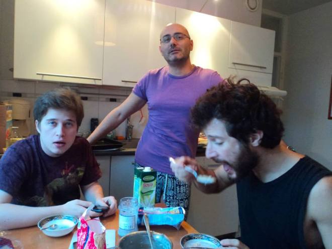 The creepy guy is eating while other couchsurfers are scared of him