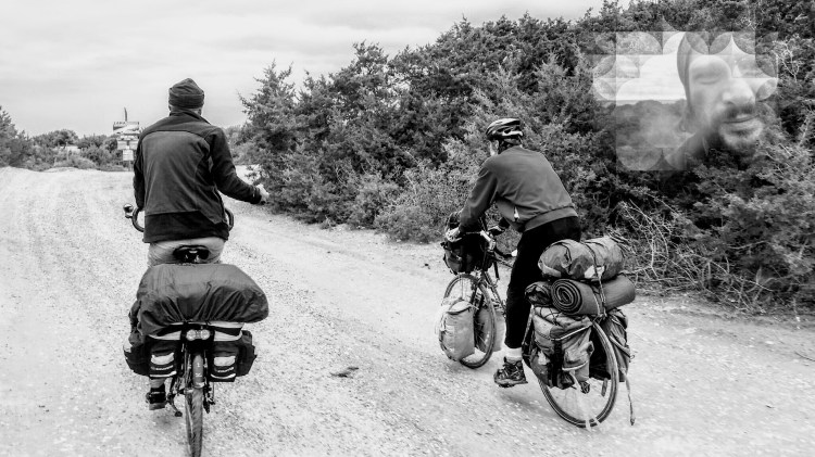 Two men on two bicycles bike touring in the nature